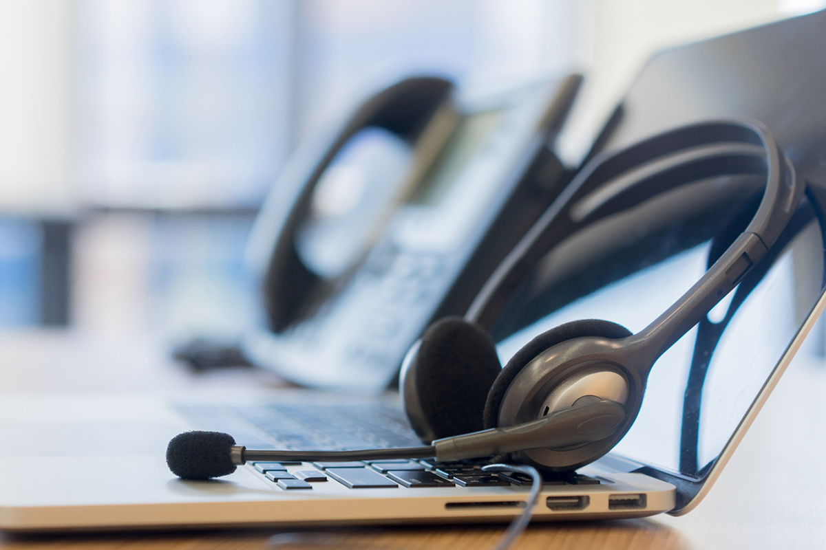 A headset on a computer__Description automatically generated